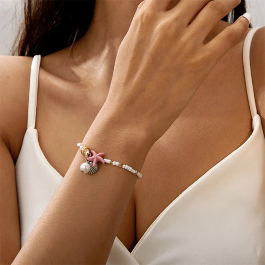 EtherealBe bohemian beach bracelet featuring seashells and pink starfish on a delicate strand