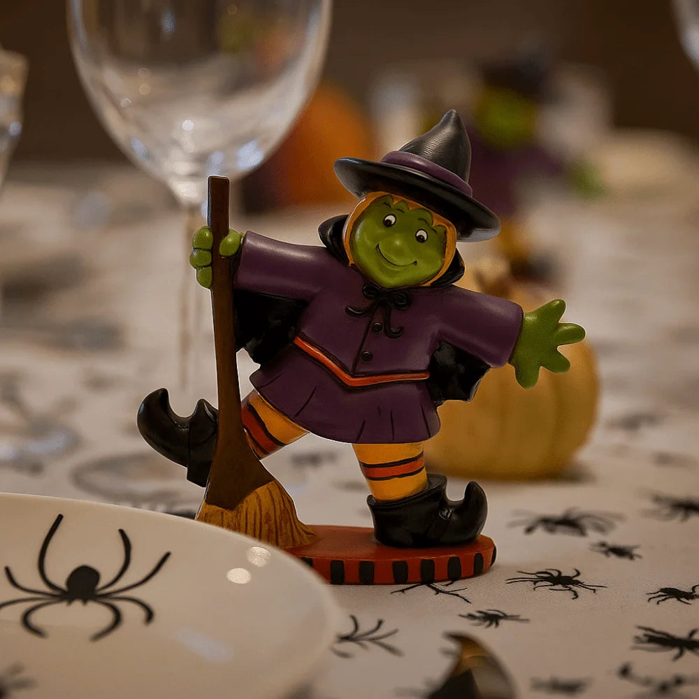 Colorful Halloween witch figurine with a broom, perfect for festive table decoration