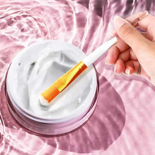 EtherealBe facial mask applicator brushes being used to apply cream from a jar