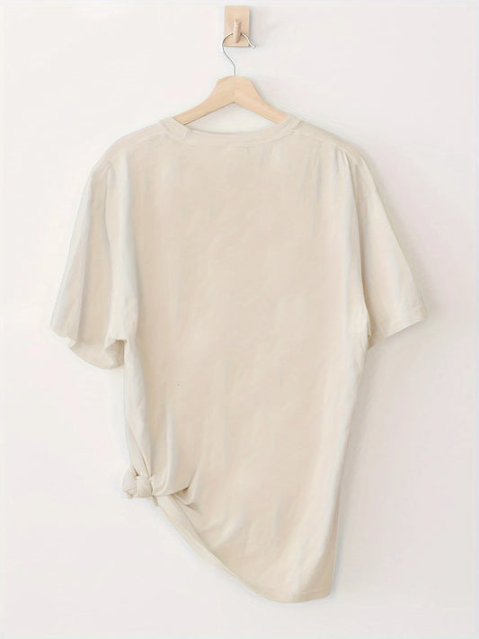 Back view of a season of the witch t-shirt in cream color with a knotted detail at the hem