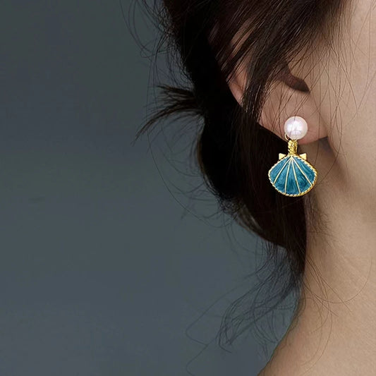 EtherealBe blue shell pearl dangle earrings featuring a delicate design with a pearl centerpiece