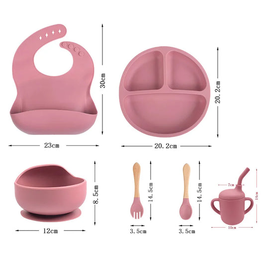 EtherealBe children's silicone tableware set with a bib, divided plate, bowl, and utensils in soft pink