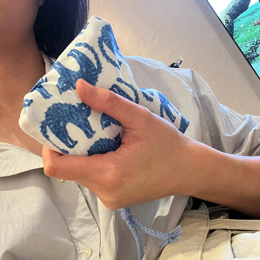 EtherealBe blue cat makeup bag held in hand, featuring playful blue cat designs on a white background