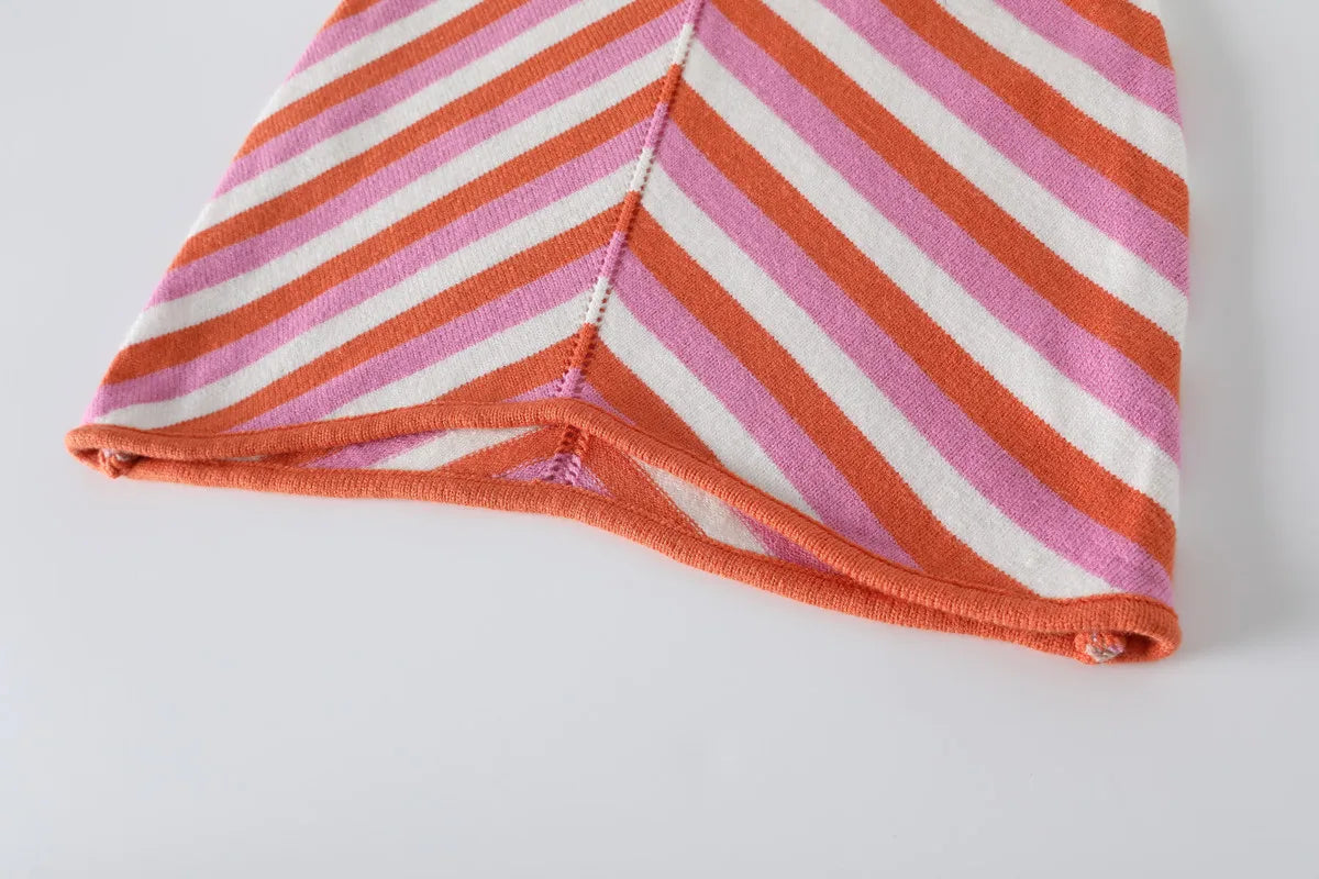 Chic sleeveless lace-up halter dress in colorful striped fabric with a stylish hem detail