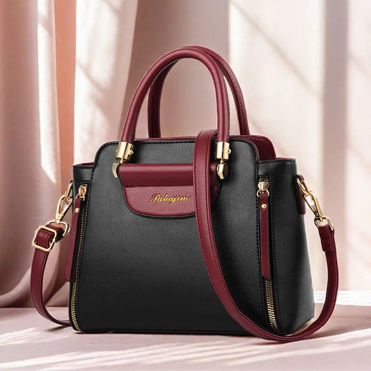 Black and burgundy leather structured handbag with gold hardware and detachable strap trendsetting handbags for women 2025
