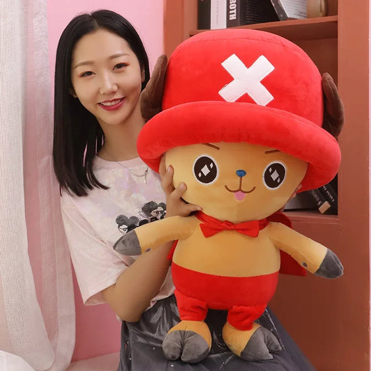 Cute Tony Tony Chopper plush doll held by a smiling woman in a cozy room