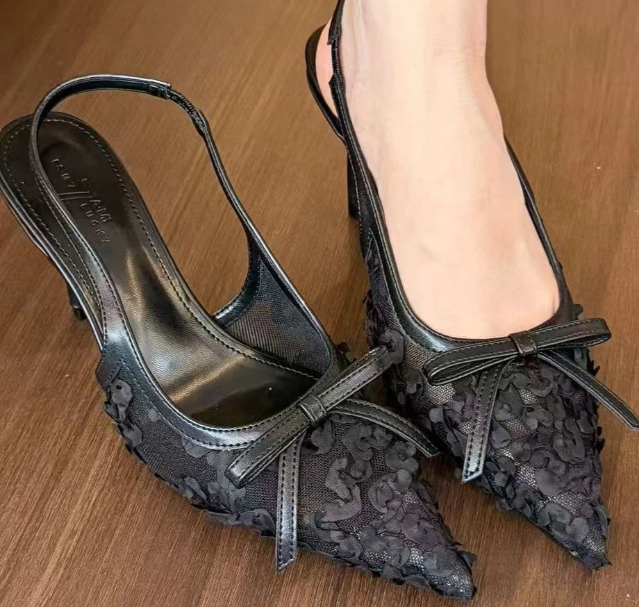 Black lace slingback heels for women with bow detail and pointed toe style