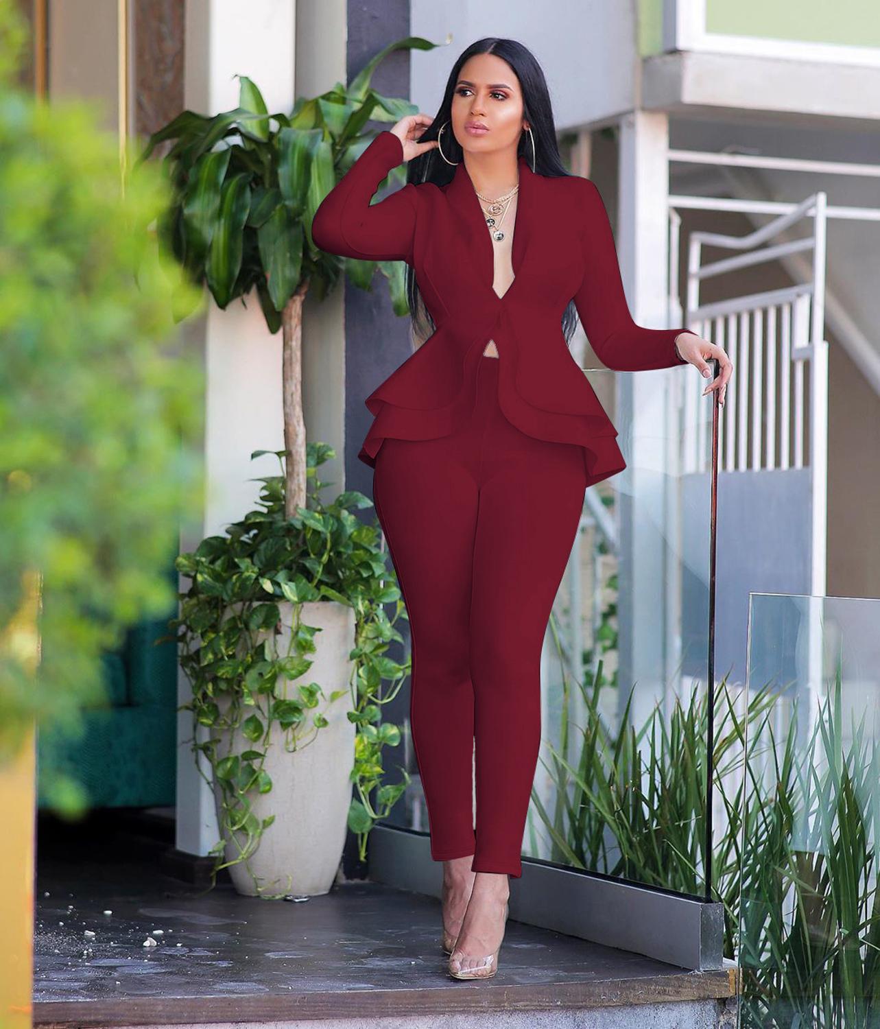 Model wearing burgundy women ruffle blazer pants set with peplum tiers slim ankle pants and heels