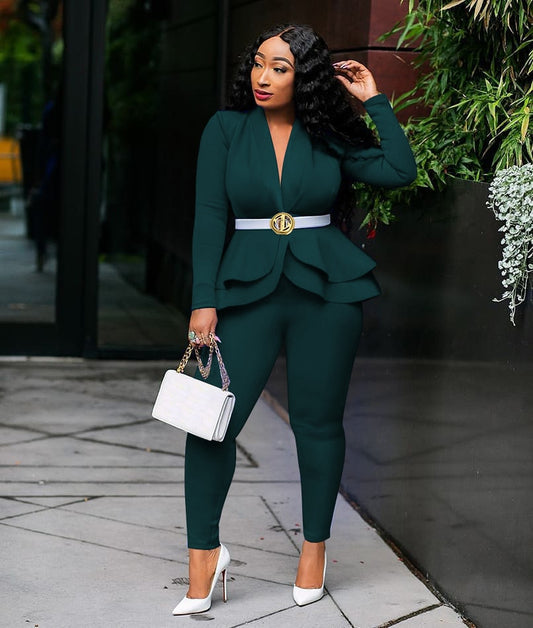 Model wearing emerald green women ruffle blazer pants set with white belt gold buckle handbag and heels
