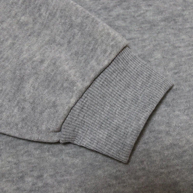 Close-up of the sleeve of a gray Halloween witch hat sweatshirt for women featuring ribbed cuffs