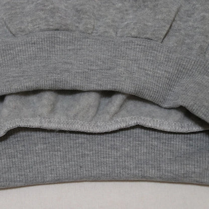 Close-up of the hem of a grey Halloween witch hat sweatshirt for women highlighting soft fabric details