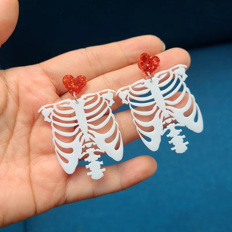 EtherealBe Halloween earrings for women featuring ribcage design with glitter heart accents