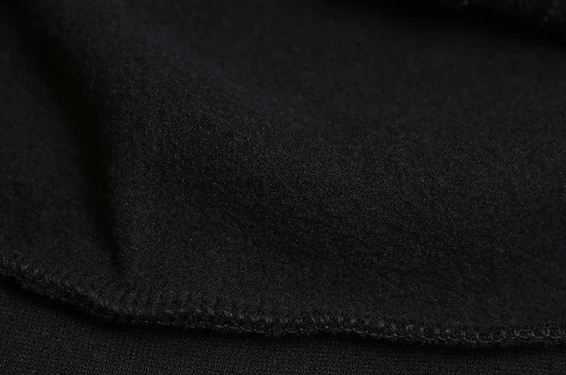 Closeup of black brushed fleece lining and seam detail of spider web zipper hoodie for women showing soft interior