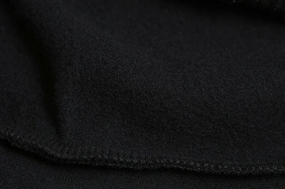 Closeup of black brushed fleece lining and seam detail of spider web zipper hoodie for women showing soft interior