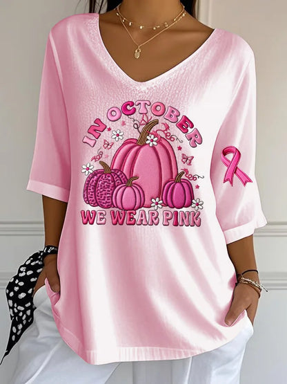 Women's Halloween graphic t-shirt in pink featuring pumpkins and a breast cancer awareness ribbon