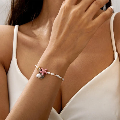 EtherealBe bohemian beach bracelet featuring seashells and pink starfish on a delicate strand