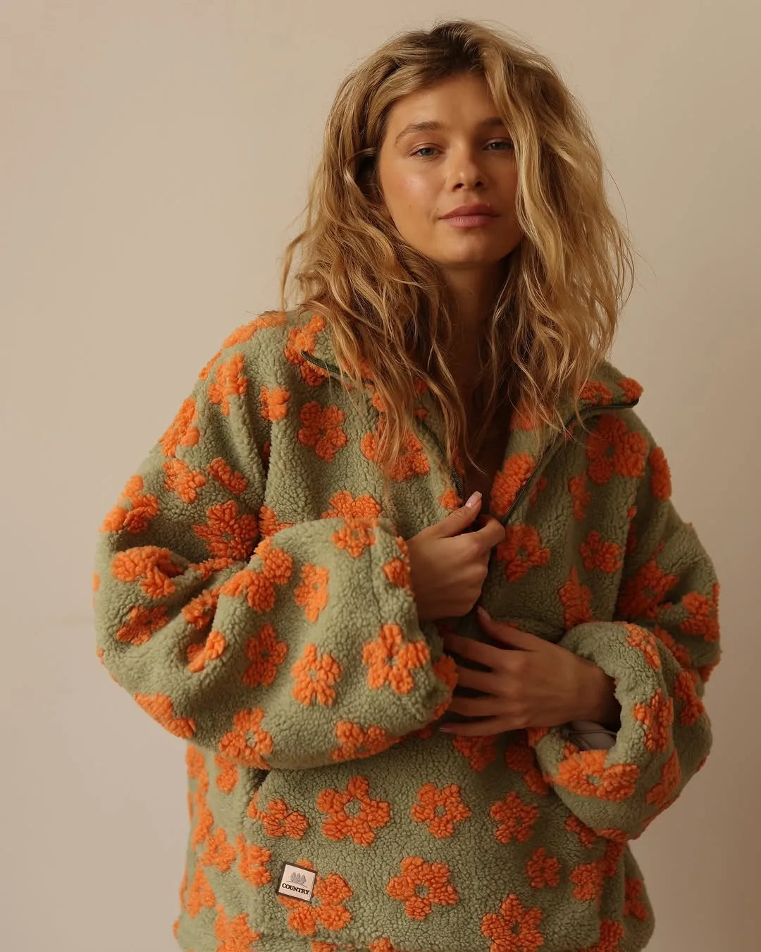 EtherealBe cozy lambskin coat for women in green with orange floral patterns for a stylish look