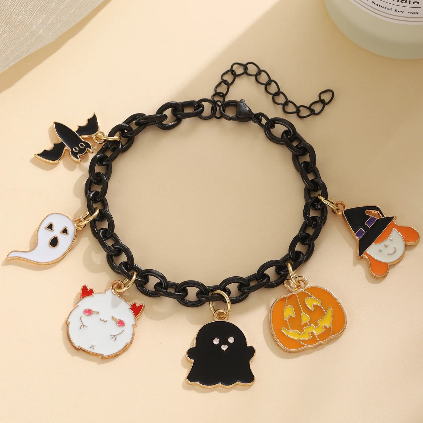 Black Halloween charm bracelet for women featuring spooky charms like ghosts and pumpkins