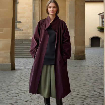 Model wearing a simple style long sleeve trench coat in deep burgundy for a chic look.