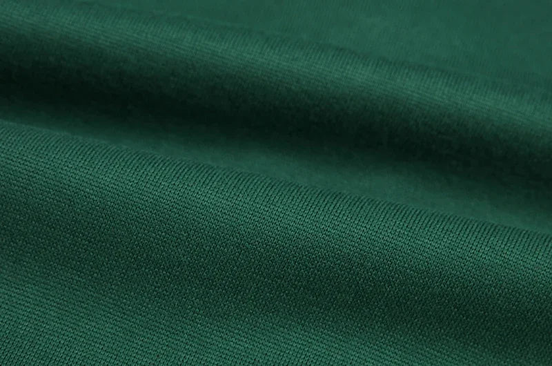 Close up dark green fabric texture of EtherealBe spider web zipper hoodie for women showing knit detail