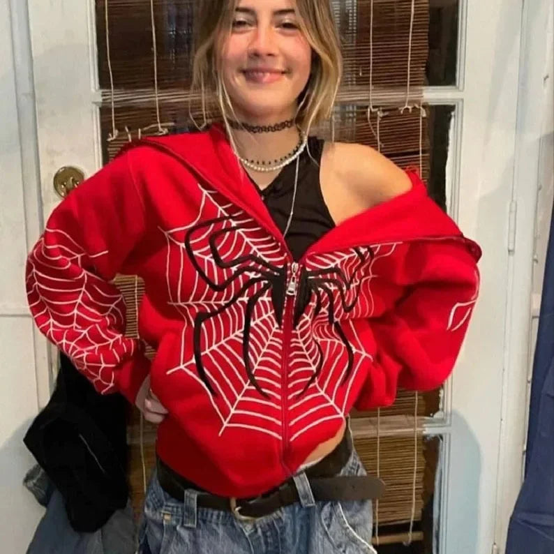 Smiling woman wearing red spider web zipper hoodie for women with black spider graphic and oversized fit