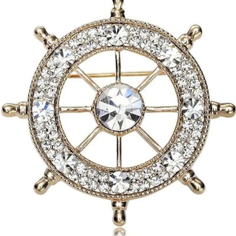 EtherealBe nautical style crystal brooch featuring a ship wheel design adorned with sparkling crystals