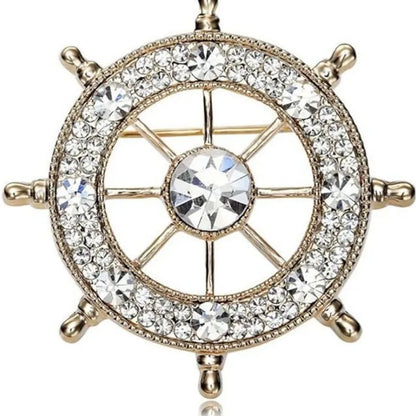 EtherealBe nautical style crystal brooch featuring a ship wheel design adorned with sparkling crystals