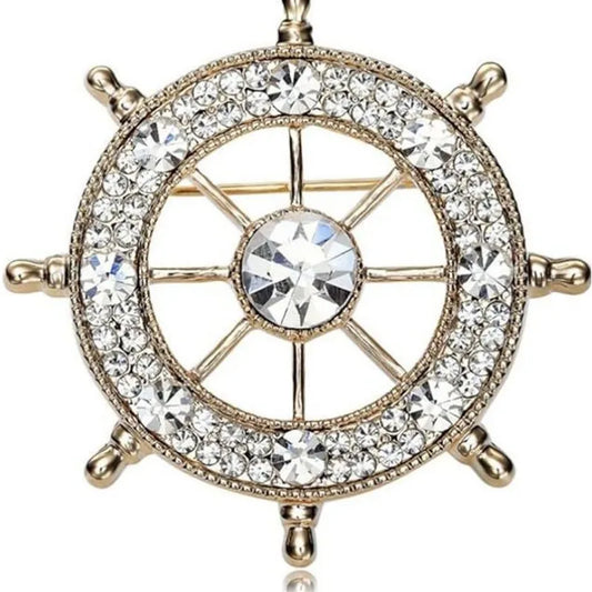 EtherealBe nautical style crystal brooch featuring a ship wheel design adorned with sparkling crystals