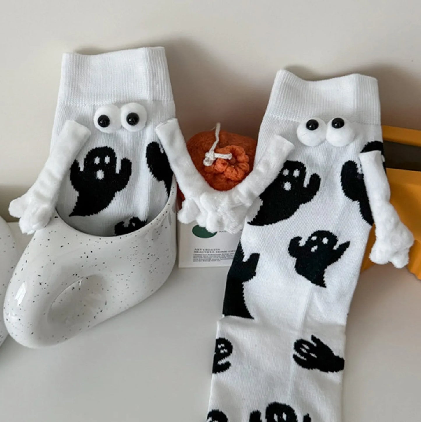 Cute women's Halloween socks featuring ghost designs and playful 3D eyes for festive style