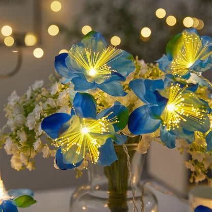 EtherealBe fairy flower string lights with vibrant blue and yellow blooms illuminating a decorative vase