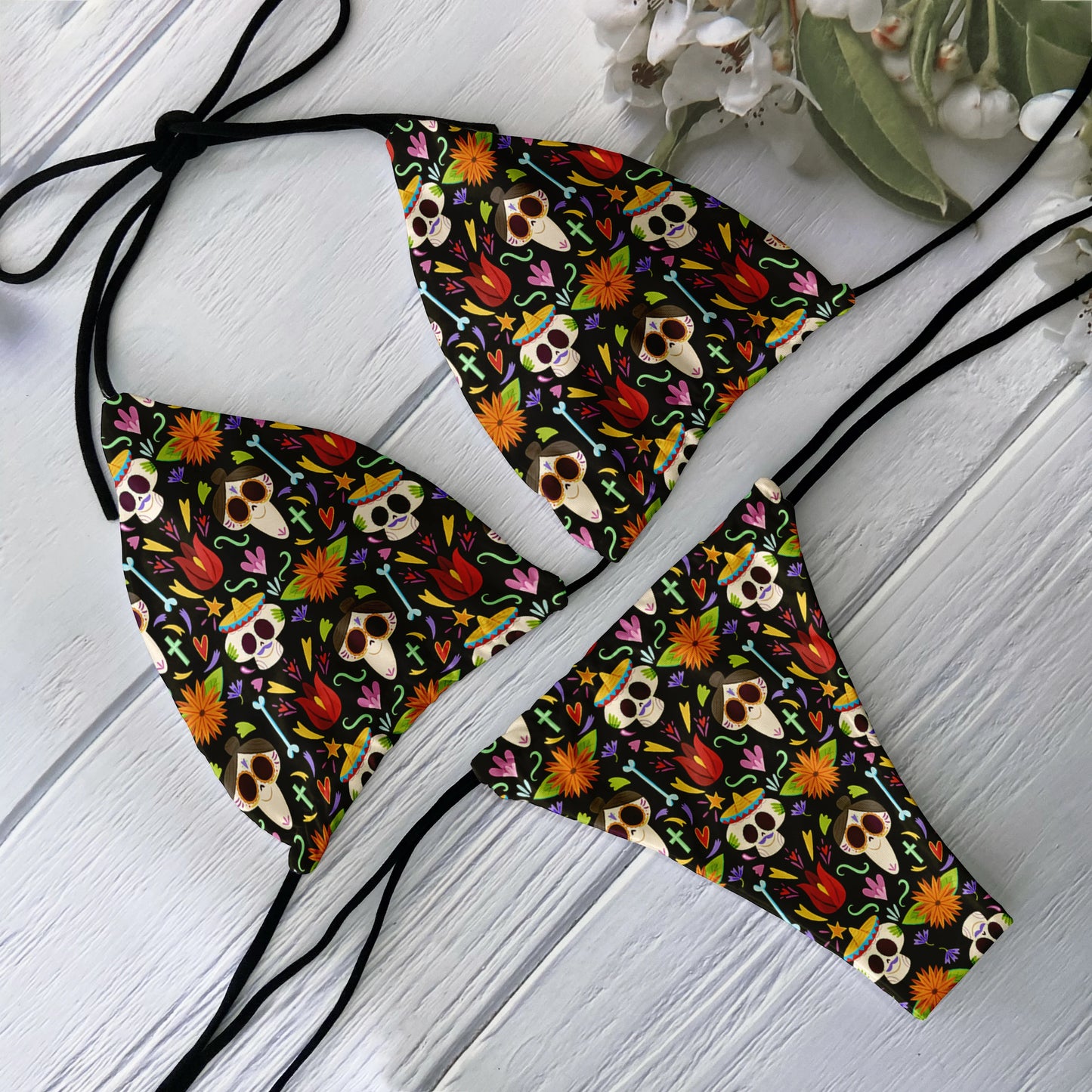 EtherealBe skull print bikini set with colorful Day of the Dead skulls and floral pattern on black string triangle top and bottoms
