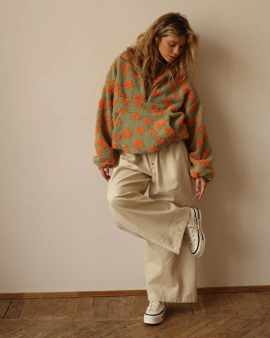 EtherealBe cozy lambskin coat for women worn over a stylish oversized sweater and wide-leg pants