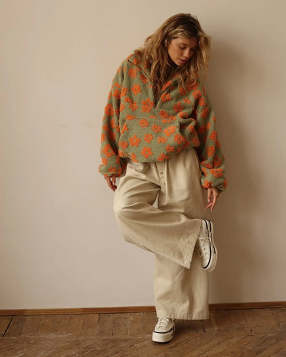 EtherealBe cozy lambskin coat for women worn over a stylish oversized sweater and wide-leg pants