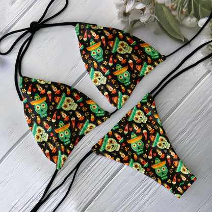 Skull print bikini set with black tie triangle top and cheeky bottoms featuring colorful Day of Dead skulls