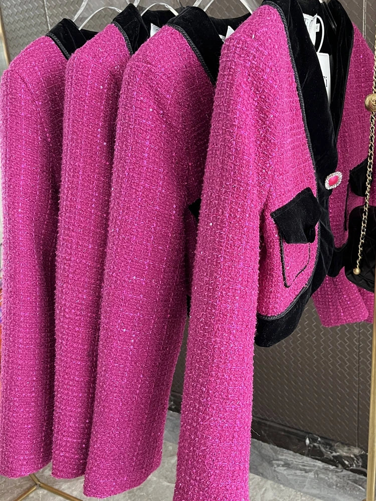 Three sweet pink tweed blazers for ladies with black accents and pockets, displayed on hangers