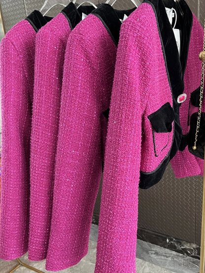 Three sweet pink tweed blazers for ladies with black accents and pockets, displayed on hangers