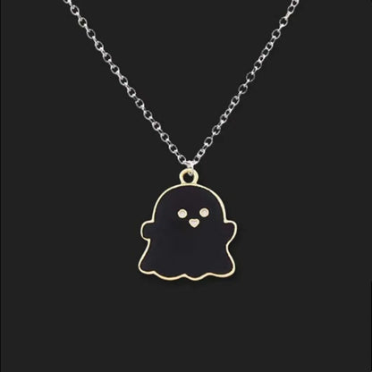 EtherealBe Halloween ghost pendant necklace in black with gold detailing on a silver chain