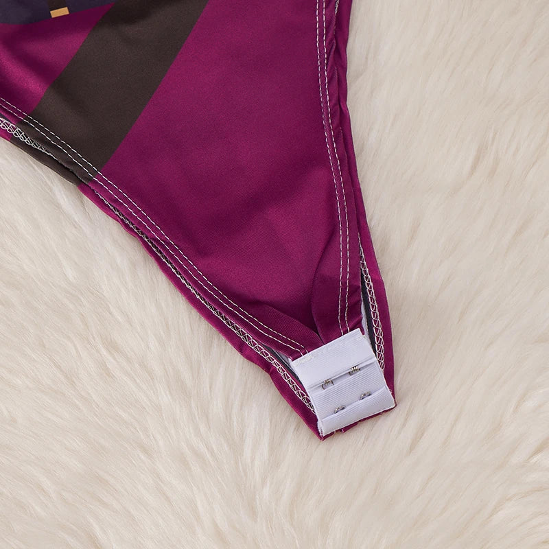 Close up of magenta bodysuit bottom with white hook closure on faux fur background kawaii cartoon bodysuit costume for women