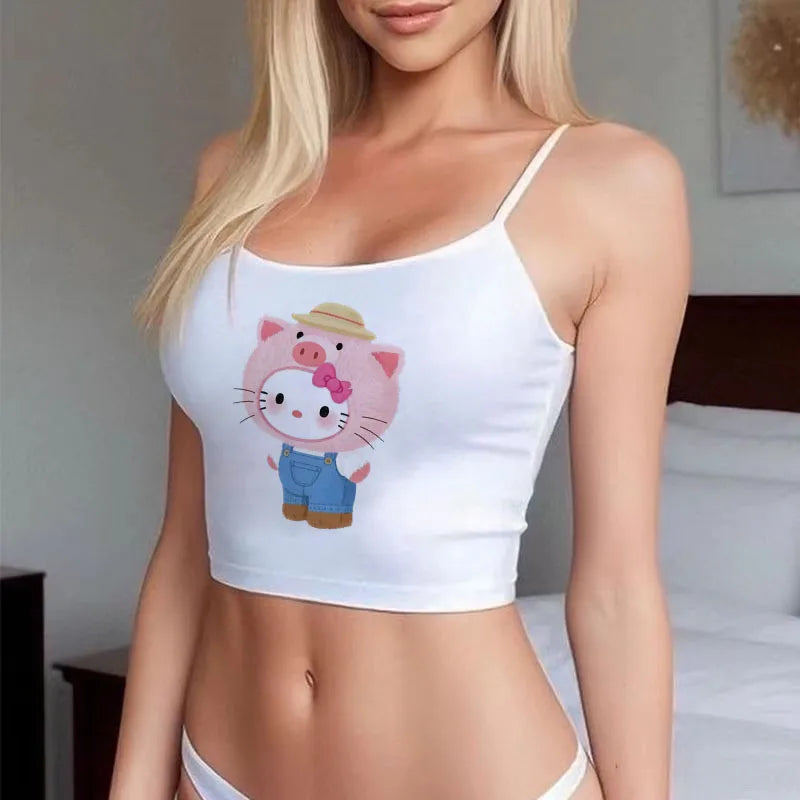 Female model wearing a white spaghetti strap Sanrio Hello Kitty cute crop top . Printed Hello Kitty in denim overalls and pig hat
