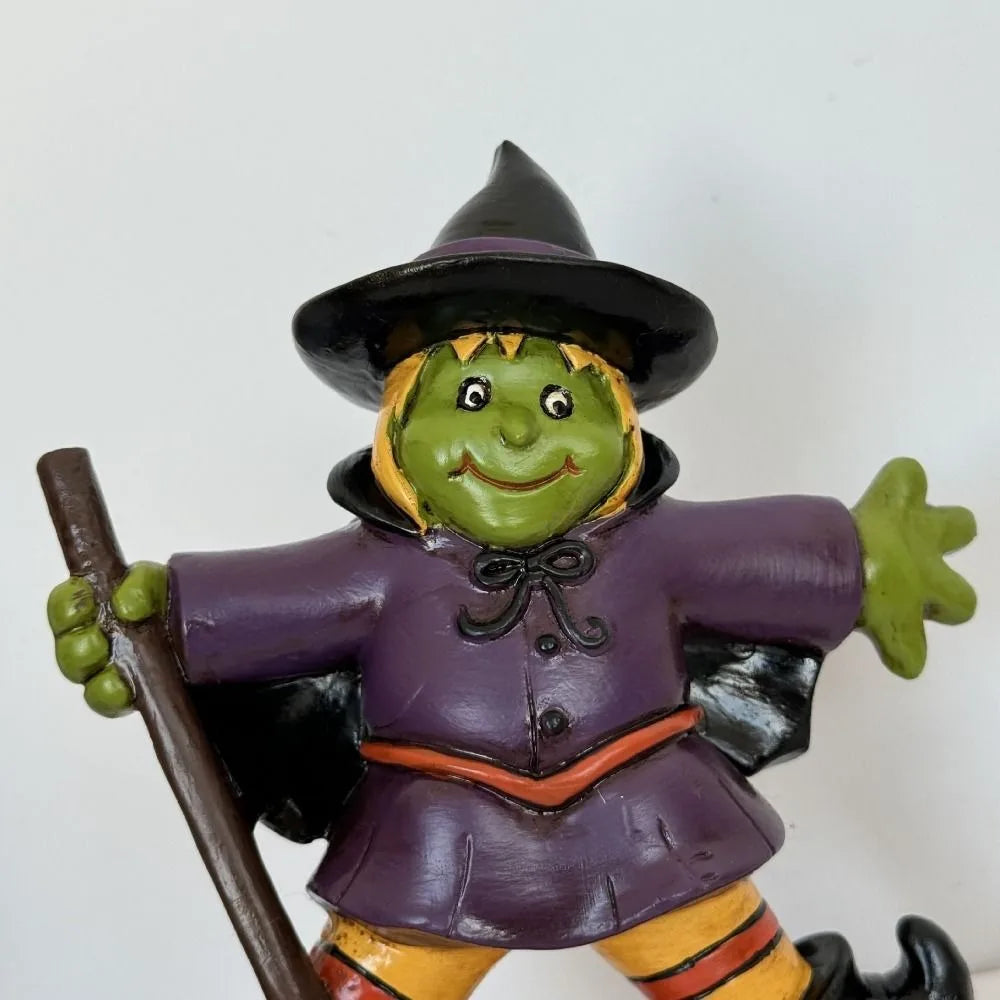EtherealBe Halloween witch figurine in purple outfit with green face and broomstick