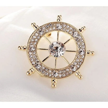 Nautical style crystal brooch featuring a ship's wheel design with sparkling rhinestones