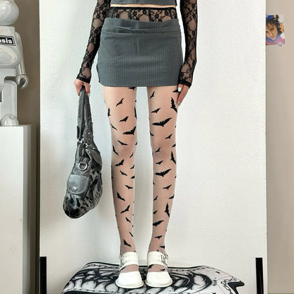 Stylish Halloween bat pattern tights for women paired with a mini skirt and lace top for a festive look