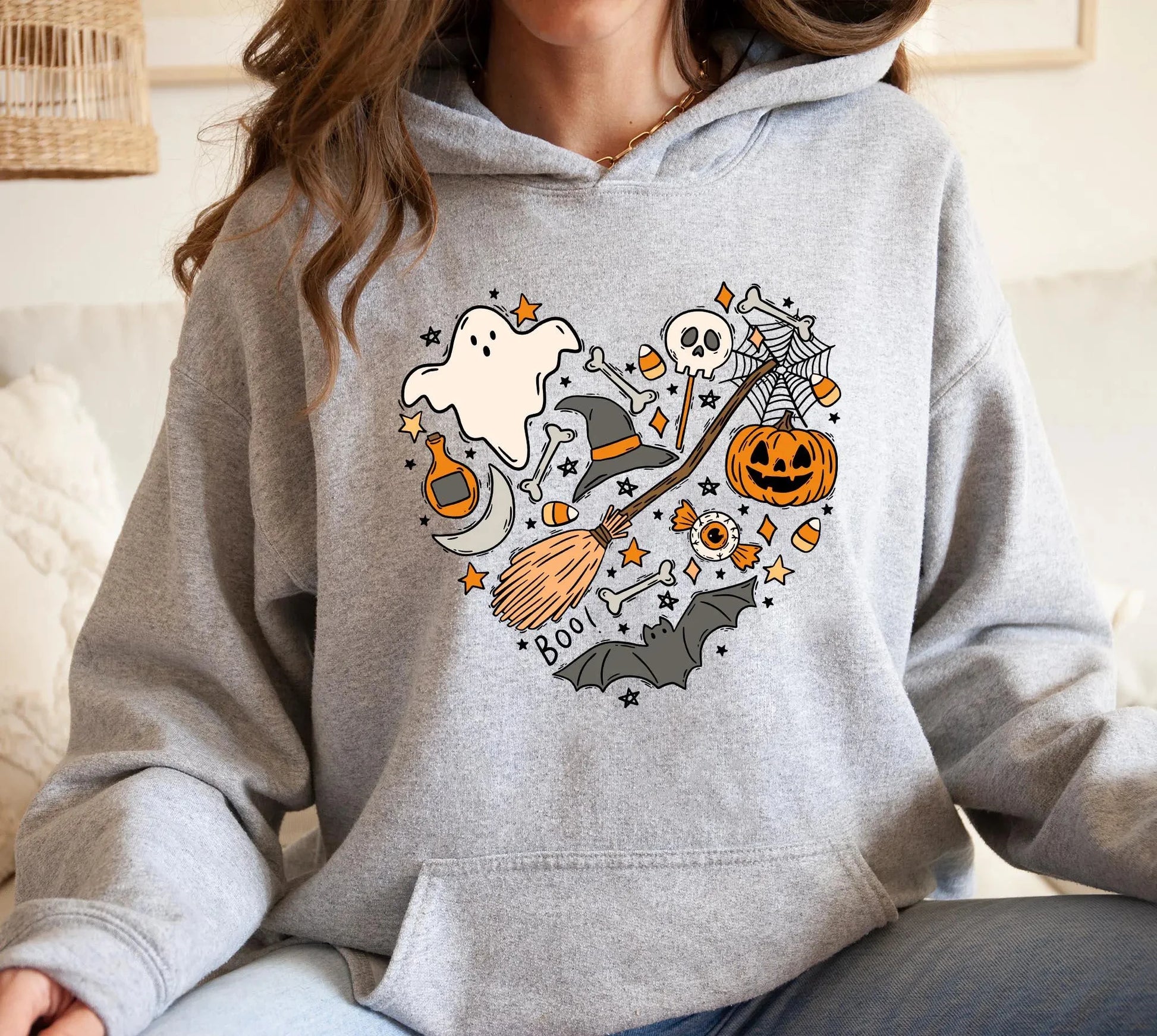 Cozy gray Halloween spooky hoodie for women featuring fun ghost and pumpkin graphics