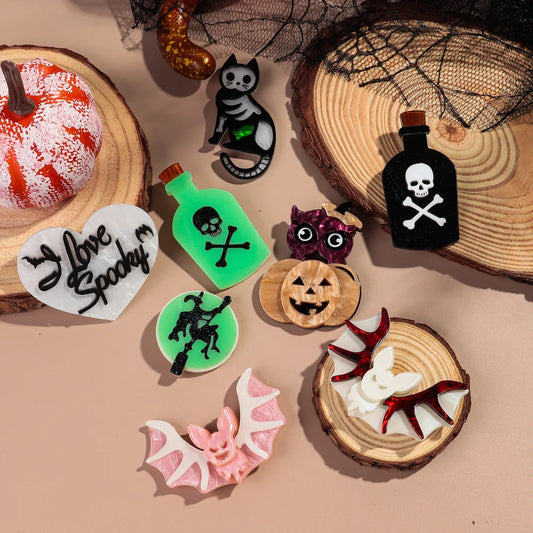 Bat and pumpkin lapel pins Halloween with spooky designs on wooden coasters