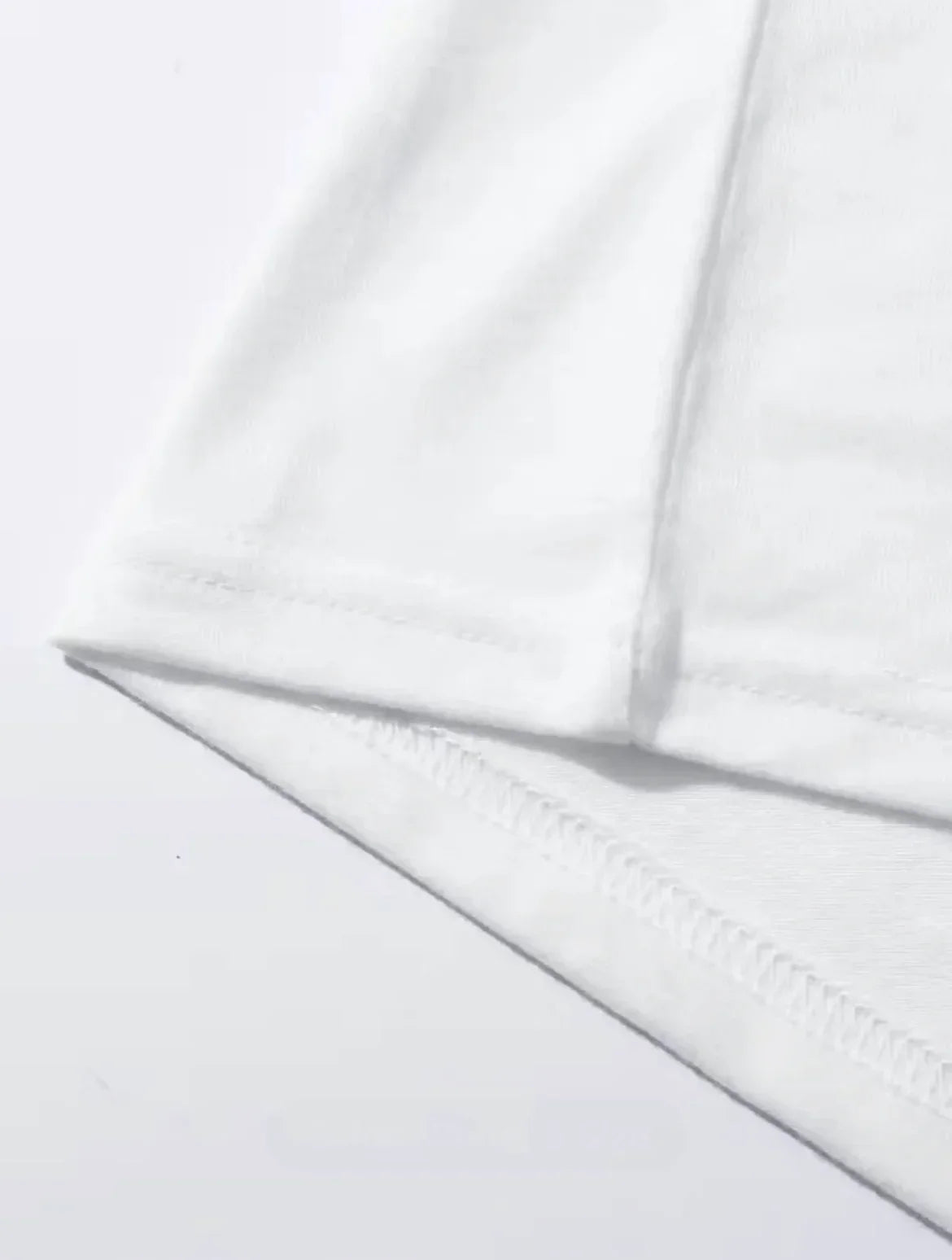 Close-up of the hem and sleeve of an EtherealBe Halloween printed t-shirt for women in white fabric