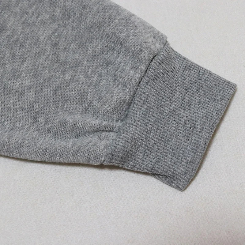 Light gray fabric close-up of a Halloween witch hat sweatshirt for women showcasing sleeve detail
