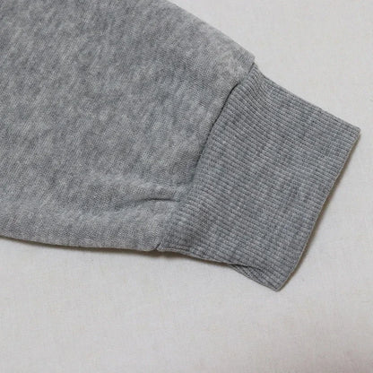 Light gray fabric close-up of a Halloween witch hat sweatshirt for women showcasing sleeve detail