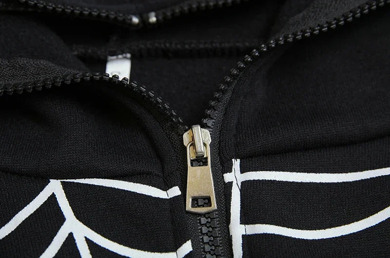 Close up of black spider web zipper hoodie for women showing metal zipper and white web print on fabric