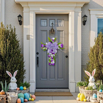 Purple tulip cross wall hanging decorated with greenery for a charming front door display