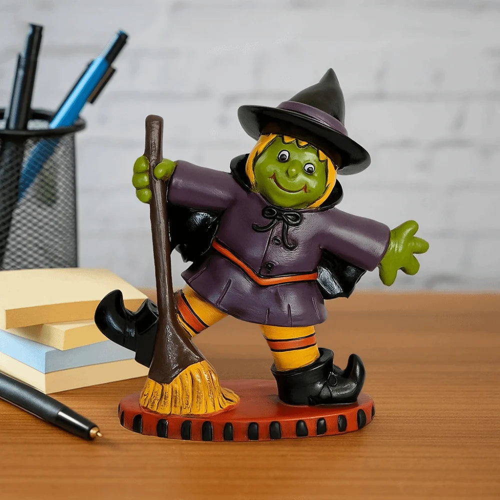 Colorful Halloween witch figurine with a broomstick and a playful pose on a desk